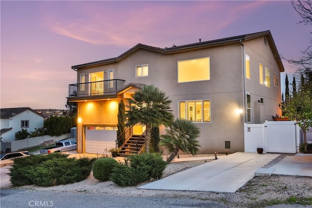 13083 Via Tuscany, Riverside, CA 92503 - view of front of house featuring a balcony, stucco siding, stairs, and a garage