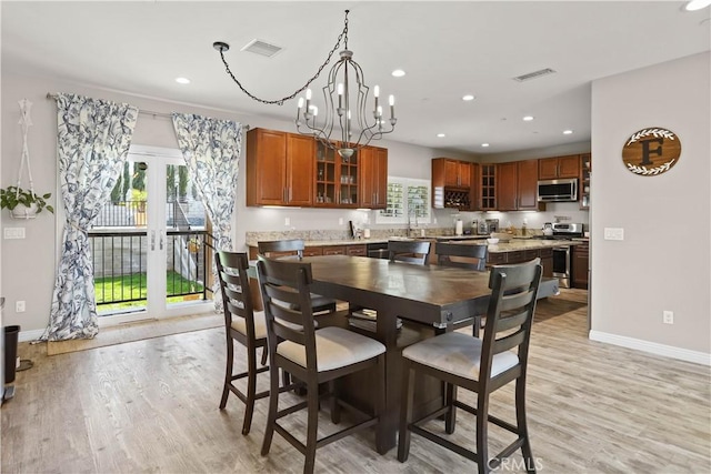 13083 Via Tuscany, Riverside, CA 92503 - dining area featuring light wood finished floors, recessed lighting, baseboards, a chandelier, and french doors