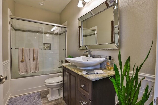 13083 Via Tuscany, Riverside, CA 92503 - full bath featuring toilet, vanity, enclosed tub / shower combo, and wood finished floors