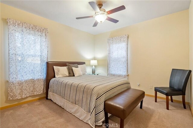 bedroom featuring baseboards, carpet flooring, and a ceiling fan