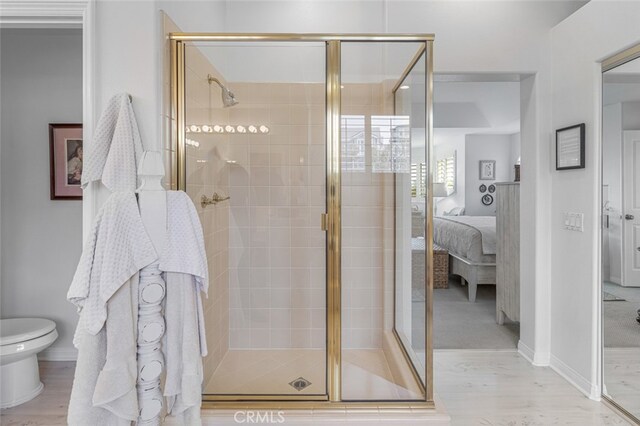 25382 Village Rd, Dana Point, CA 92629 - full bath with ensuite bath, a shower stall, toilet, and wood finished floors