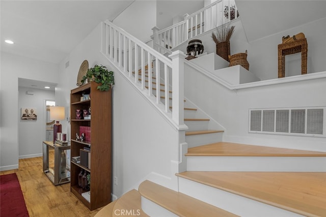 25382 Village Rd, Dana Point, CA 92629 - staircase featuring wood finished floors, recessed lighting, and baseboards