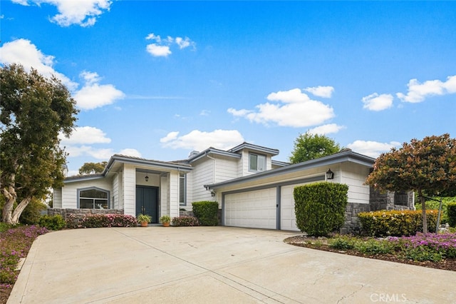 25382 Village Rd, Dana Point, CA 92629 - view of front of property with stone siding, a garage, and driveway