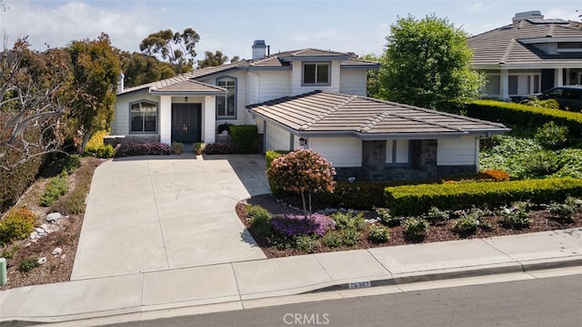 25382 Village Rd, Dana Point, CA 92629 - view of front of house with concrete driveway, a tiled roof, an attached garage, and a chimney