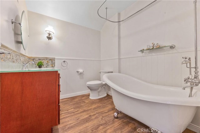 11330 Whitley St, Whittier, CA 90601 - bathroom featuring a freestanding bath, wood finished floors, vanity, and a wainscoted wall
