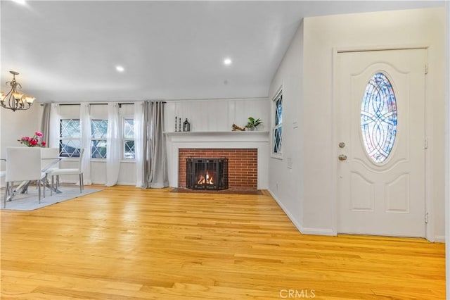 11330 Whitley St, Whittier, CA 90601 - entryway featuring wood finished floors, a chandelier, a fireplace, and recessed lighting