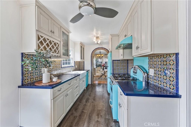 11330 Whitley St, Whittier, CA 90601 - kitchen with under cabinet range hood, dark countertops, a ceiling fan, and tasteful backsplash
