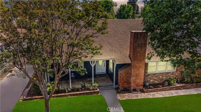 11330 Whitley St, Whittier, CA 90601 - view of front facade with a shingled roof, a front yard, a chimney, and brick siding