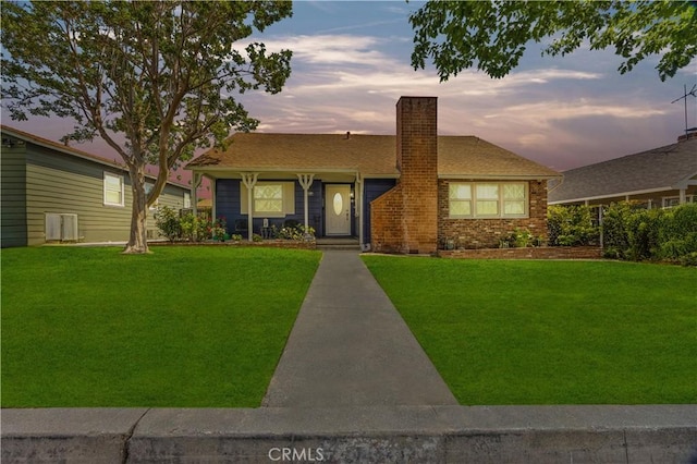 11330 Whitley St, Whittier, CA 90601 - view of front facade featuring a chimney, a yard, and brick siding