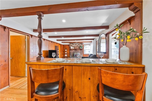 11330 Whitley St, Whittier, CA 90601 - kitchen with wood finished floors, beamed ceiling, brown cabinets, and a breakfast bar area
