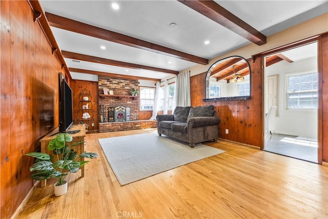 11330 Whitley St, Whittier, CA 90601 - living room featuring wood walls, wood finished floors, a brick fireplace, and beam ceiling