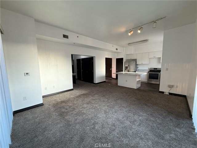 388 E Ocean Blvd Unit 212, Long Beach, CA 90802 - unfurnished living room with baseboards, visible vents, dark colored carpet, and rail lighting
