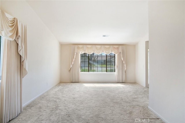 unfurnished room with carpet flooring and visible vents