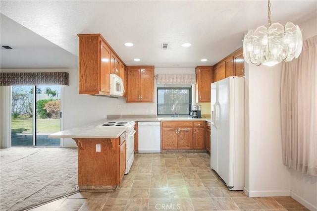 kitchen featuring light countertops, brown cabinetry, a peninsula, and white appliances