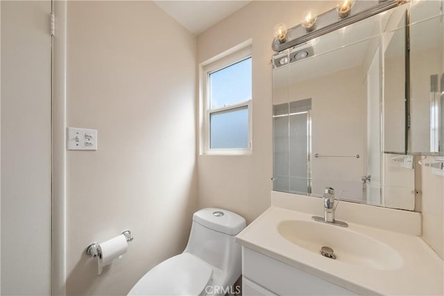 bathroom featuring toilet and vanity