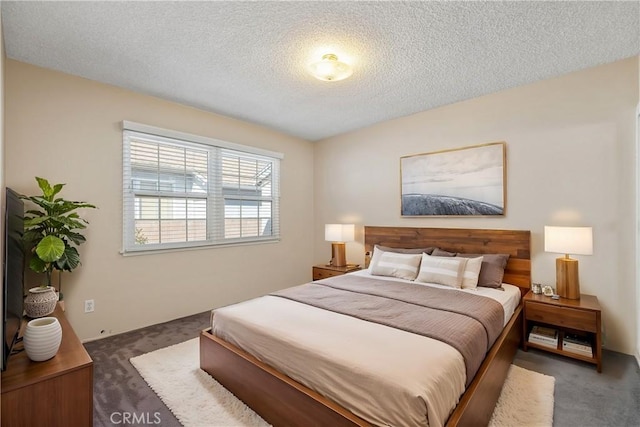 bedroom featuring carpet flooring and a textured ceiling
