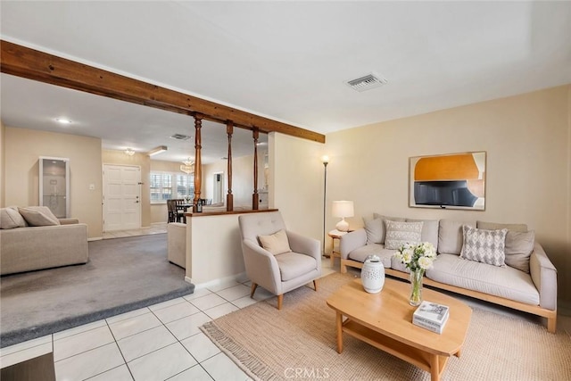 living room featuring visible vents, beamed ceiling, baseboards, light tile patterned floors, and light colored carpet