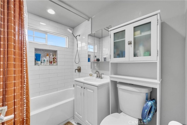 full bath featuring toilet, vanity, and  shower combination