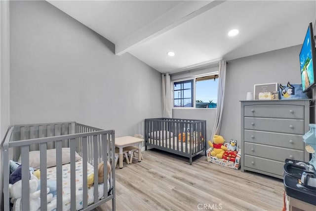 bedroom with recessed lighting, lofted ceiling with beams, and wood finished floors
