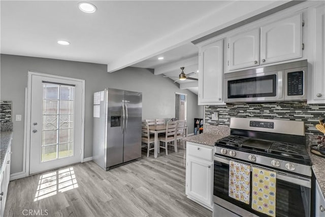 kitchen featuring lofted ceiling with beams, ceiling fan, backsplash, and stainless steel appliances