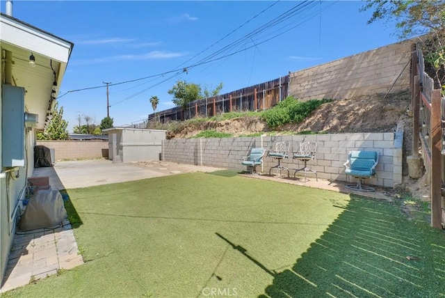 view of yard with a fenced backyard and a patio area