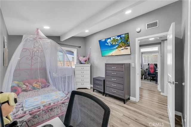 bedroom featuring multiple windows, visible vents, baseboards, and light wood-type flooring