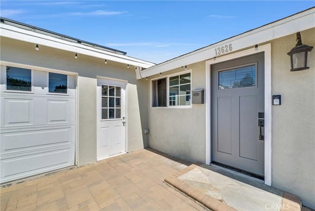 entrance to property with stucco siding