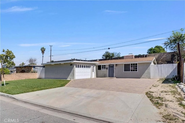 ranch-style home with driveway, stucco siding, an attached garage, fence, and a front lawn