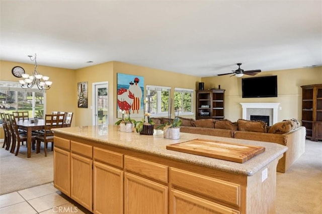 1100 N Ferrocarril Rd, Atascadero, CA 93422 - kitchen with light colored carpet, a fireplace, a ceiling fan, a chandelier, and decorative light fixtures