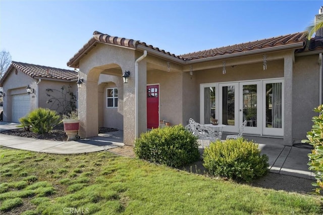 1100 N Ferrocarril Rd, Atascadero, CA 93422 - view of front of house with french doors, a garage, and stucco siding