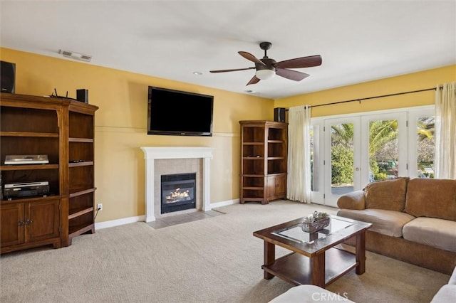 1100 N Ferrocarril Rd, Atascadero, CA 93422 - carpeted living area featuring a tile fireplace, ceiling fan, french doors, and baseboards