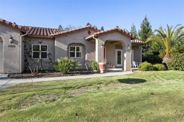 1100 N Ferrocarril Rd, Atascadero, CA 93422 - mediterranean / spanish house with a front yard, a tile roof, an attached garage, and stucco siding