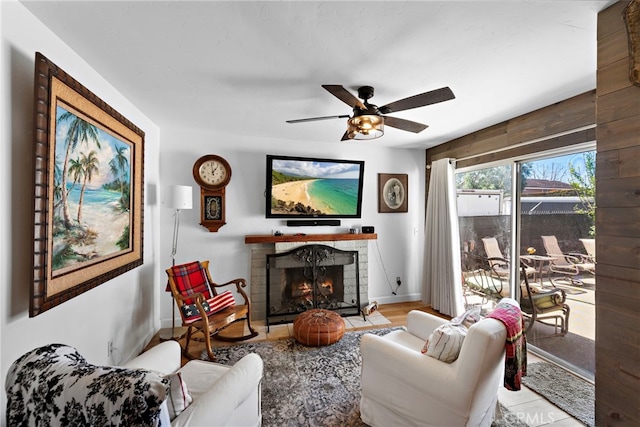 31351 Calle Del Campo, San Juan Capistrano, CA 92675 - living room featuring a warm lit fireplace, a ceiling fan, baseboards, and wood finished floors