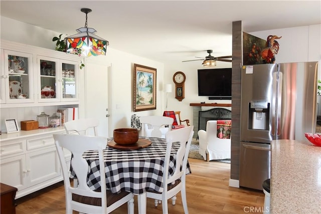 31351 Calle Del Campo, San Juan Capistrano, CA 92675 - dining space featuring a ceiling fan, light wood-style flooring, and a fireplace