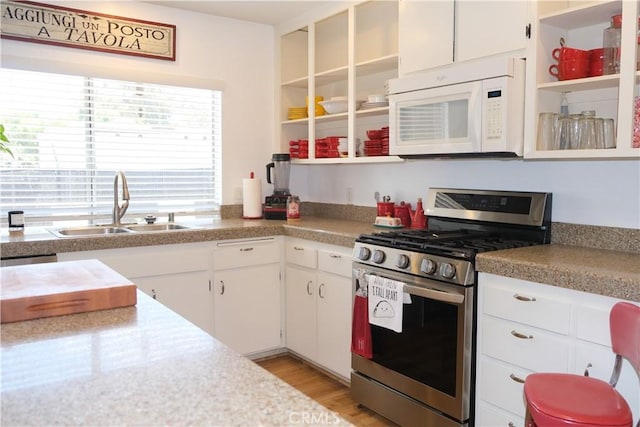 31351 Calle Del Campo, San Juan Capistrano, CA 92675 - kitchen featuring gas range, white microwave, open shelves, a sink, and white cabinets