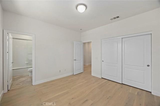 68 Sanctuary, Irvine, CA 92620 - unfurnished bedroom featuring light wood-style floors, a closet, baseboards, and ensuite bath