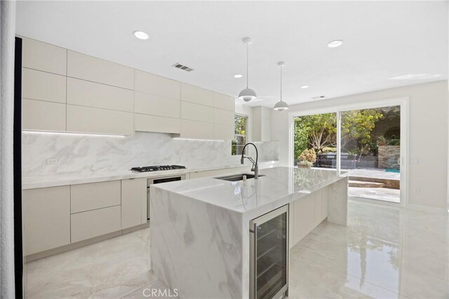 68 Sanctuary, Irvine, CA 92620 - kitchen with beverage cooler, a sink, modern cabinets, light marble finish floors, and backsplash