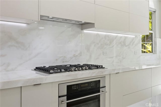 68 Sanctuary, Irvine, CA 92620 - kitchen featuring oven, white cabinets, backsplash, modern cabinets, and range hood
