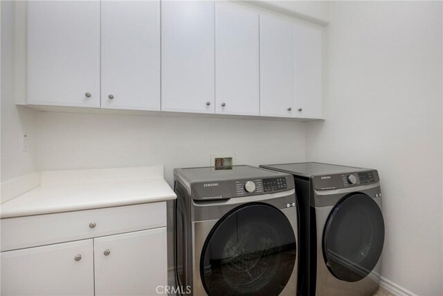 68 Sanctuary, Irvine, CA 92620 - laundry area with cabinet space, separate washer and dryer, and baseboards