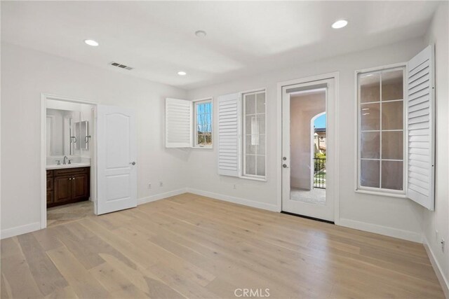 68 Sanctuary, Irvine, CA 92620 - unfurnished room with a sink, light wood finished floors, baseboards, and recessed lighting