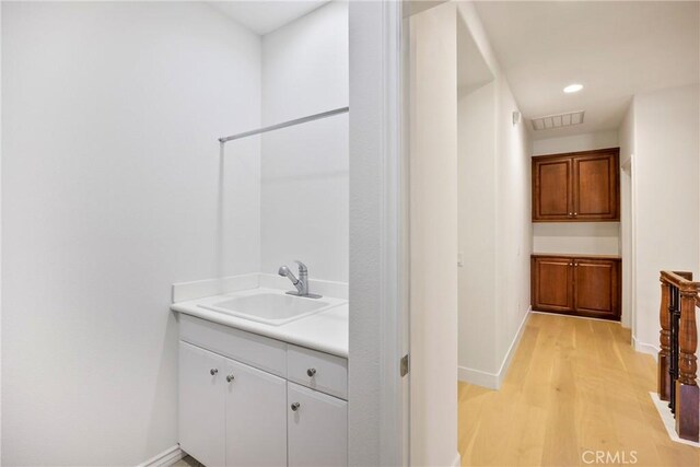68 Sanctuary, Irvine, CA 92620 - bathroom with vanity, wood finished floors, baseboards, and recessed lighting
