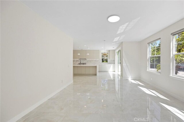 68 Sanctuary, Irvine, CA 92620 - unfurnished living room featuring baseboards, a sink, and light marble finish floors