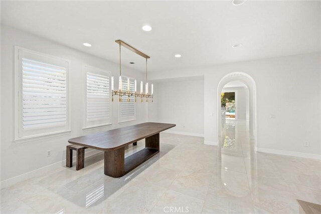 68 Sanctuary, Irvine, CA 92620 - unfurnished dining area featuring arched walkways, recessed lighting, and baseboards