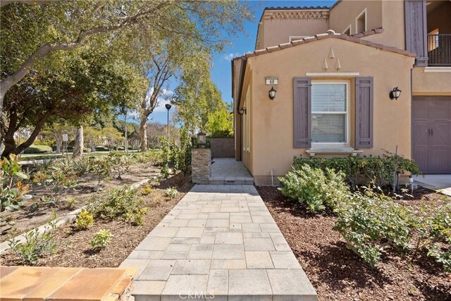 68 Sanctuary, Irvine, CA 92620 - view of side of home featuring stucco siding
