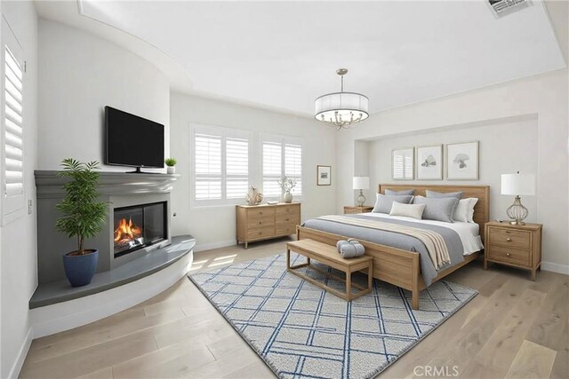 68 Sanctuary, Irvine, CA 92620 - bedroom featuring baseboards, wood finished floors, and a chandelier
