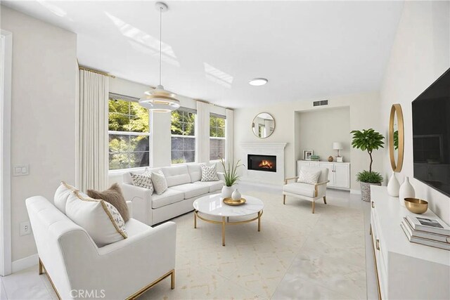 68 Sanctuary, Irvine, CA 92620 - living room featuring a warm lit fireplace and baseboards