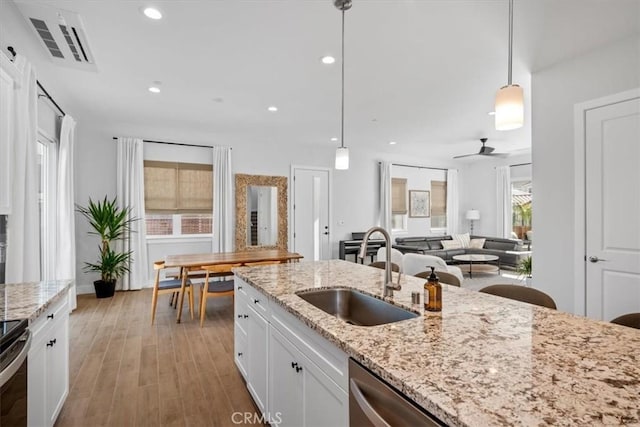 160 Earthwood Ln, San Luis Obispo, CA 93401 - kitchen with white cabinetry, light wood-style flooring, a sink, and visible vents