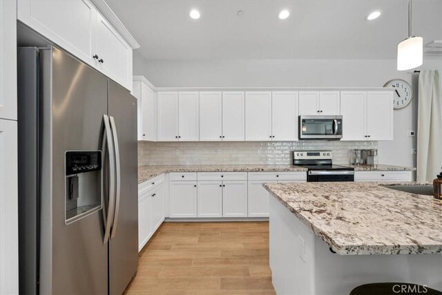 160 Earthwood Ln, San Luis Obispo, CA 93401 - kitchen featuring light wood-style floors, white cabinets, backsplash, and appliances with stainless steel finishes