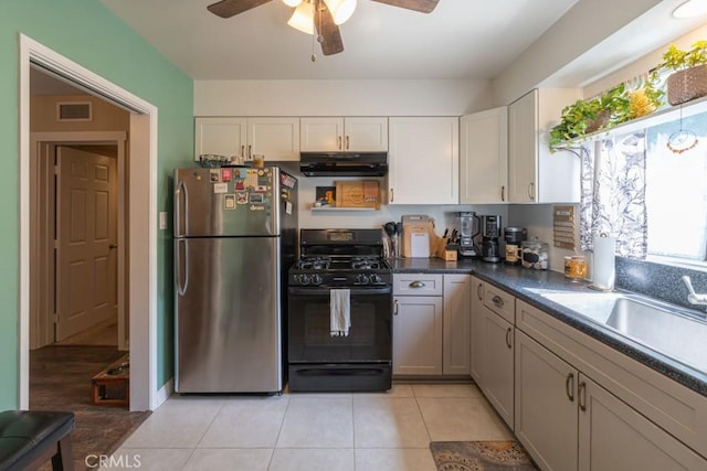 5270 E Anaheim Rd Unit 2, Long Beach, CA 90815 - kitchen with freestanding refrigerator, black range with gas stovetop, range hood, ceiling fan, and light tile patterned flooring