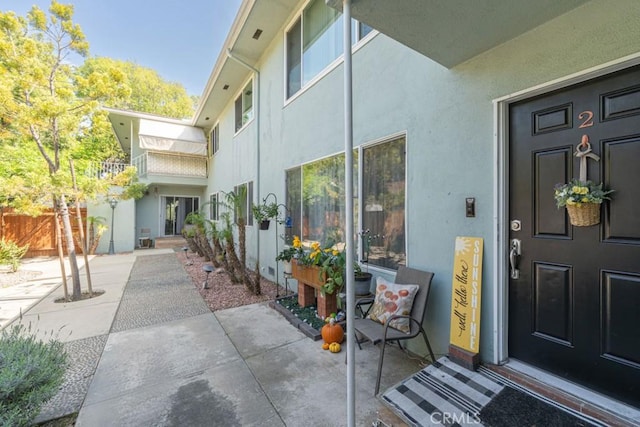 5270 E Anaheim Rd Unit 2, Long Beach, CA 90815 - doorway to property with stucco siding, a patio area, and fence